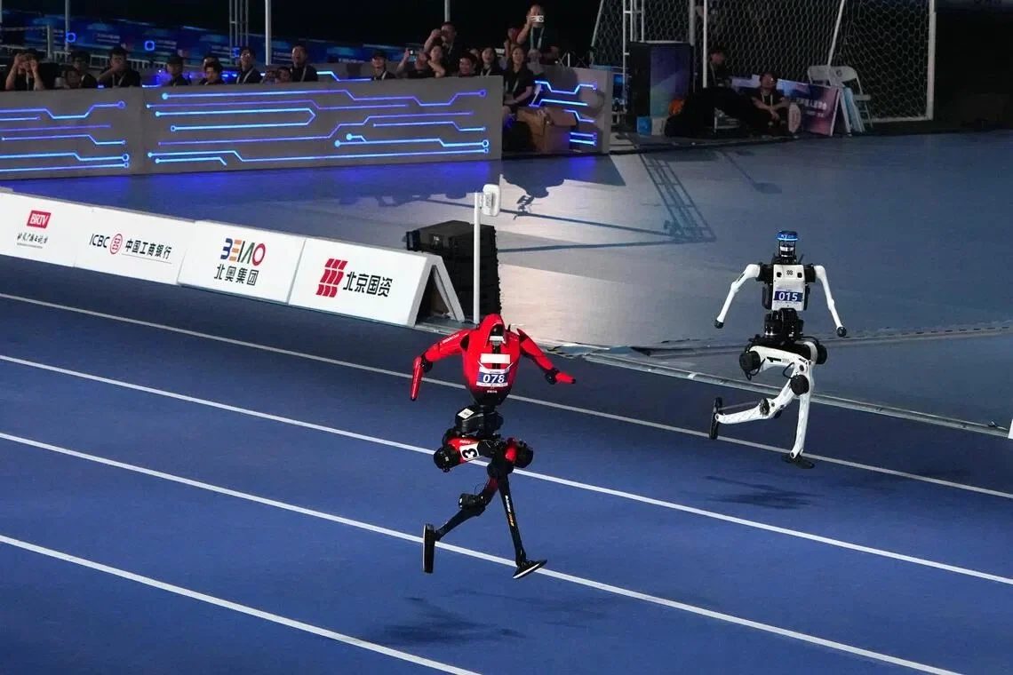 Two humanoid robots sprint in the 100-meter event at the World Humanoid Robot Games